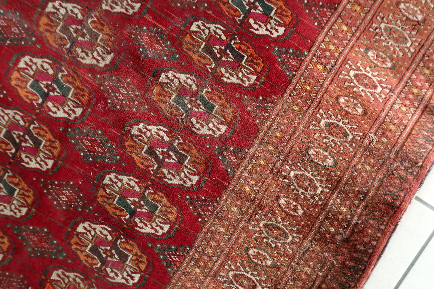 Texture shot showing the dense, velvety wool pile of the tribal weaving.

