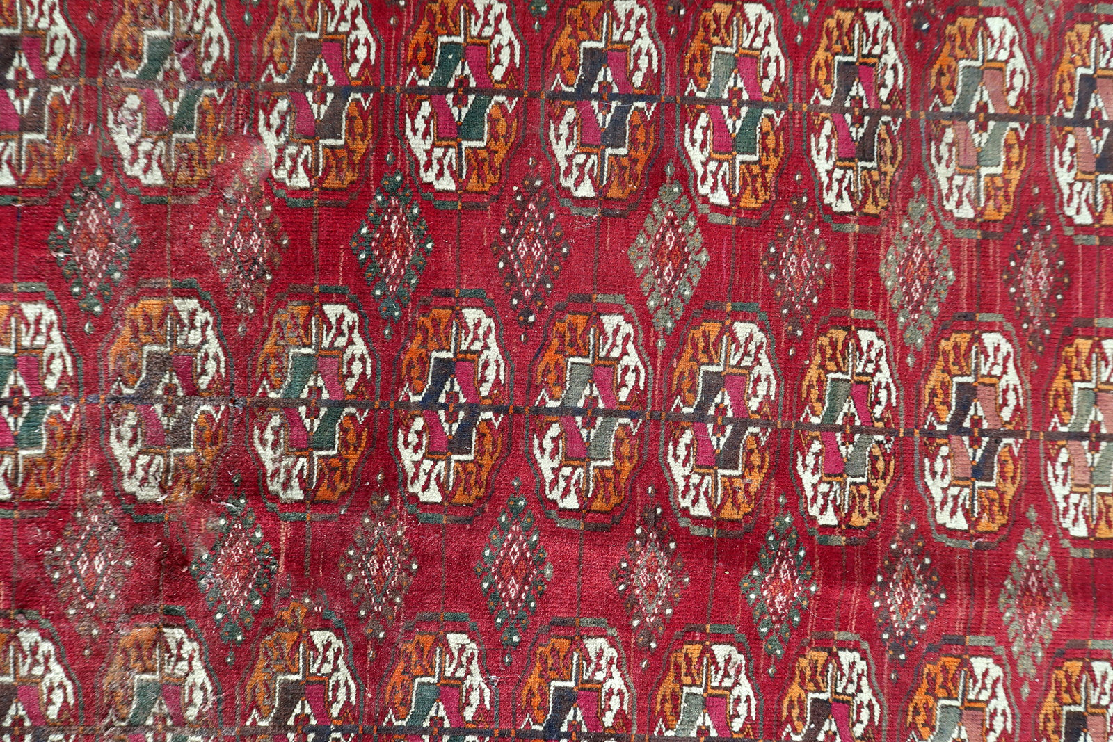 Angle shot capturing the rich patina and even wear on the antique surface.

