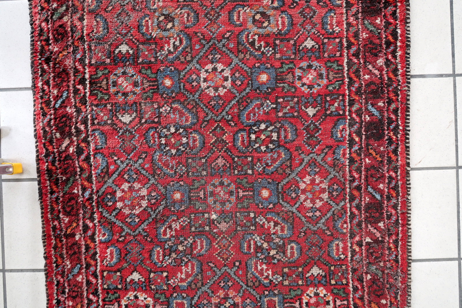 Distressed antique Hamadan runner showing authentic aged character
