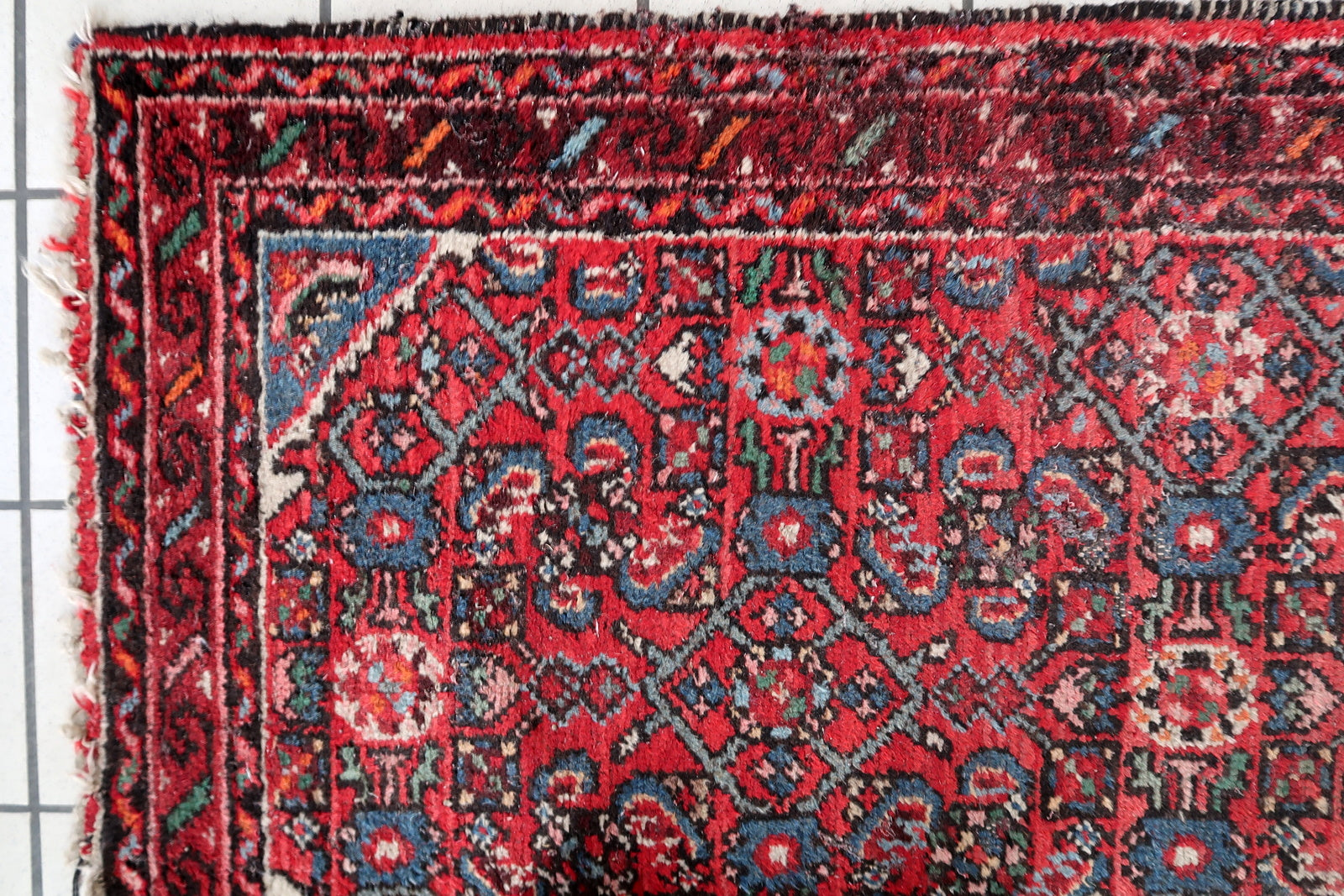 Antique Persian Hamadan runner - close-up of geometric medallions and tribal motifs
