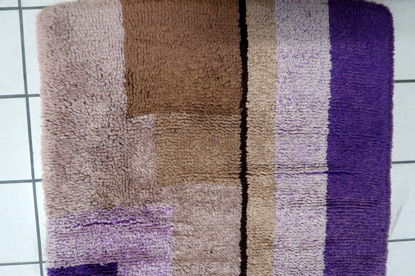 Close-up detail of the abstract, block-like geometric forms in purple and brown.

