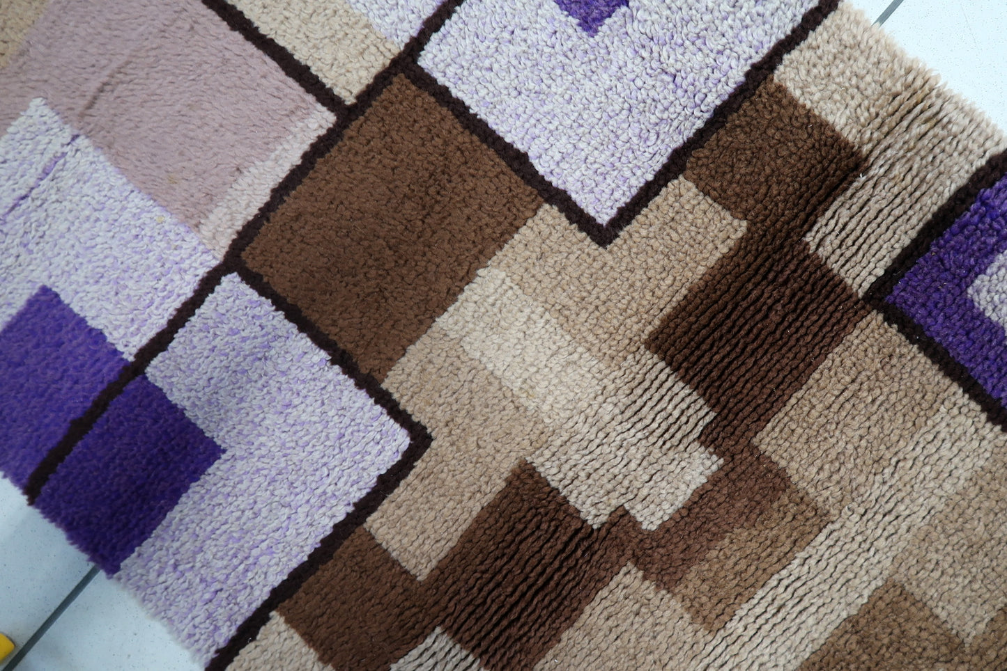 Close-up of the high-quality wool texture and machine-made weave.

