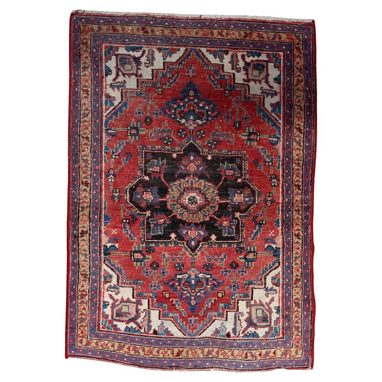 Full top view of the antique Persian Heriz rug showing the central geometric medallion.

