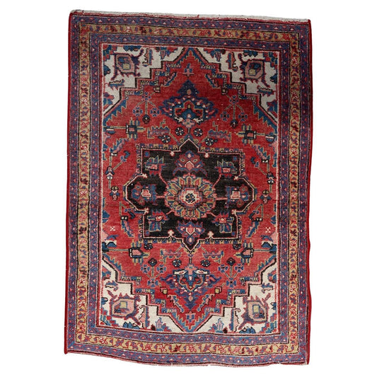 Full top view of the antique Persian Heriz rug showing the central geometric medallion.


