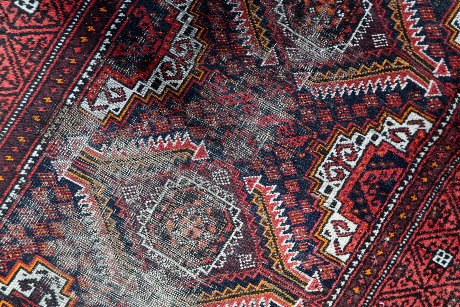 Antique Afghan rug with a dramatic vertical composition of medallions, showcasing authentic 100-year patina.

