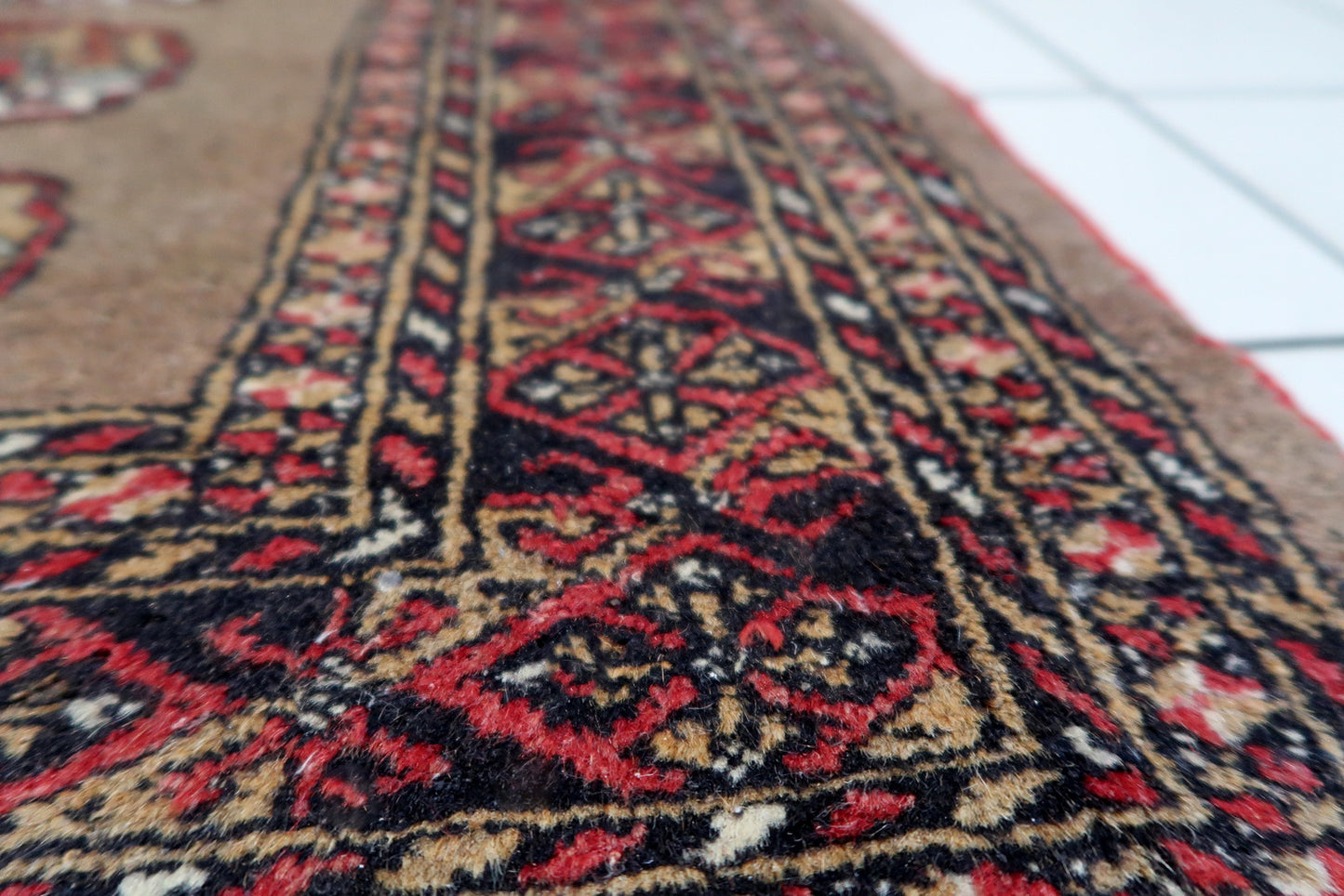 1920s Uzbek tribal rug with five vertical medallions and elegant earth-tone coloration.

