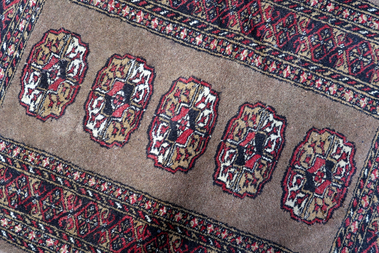 Antique Uzbek rug with a sophisticated palette of taupe, burgundy red, cream, and golden accents.

