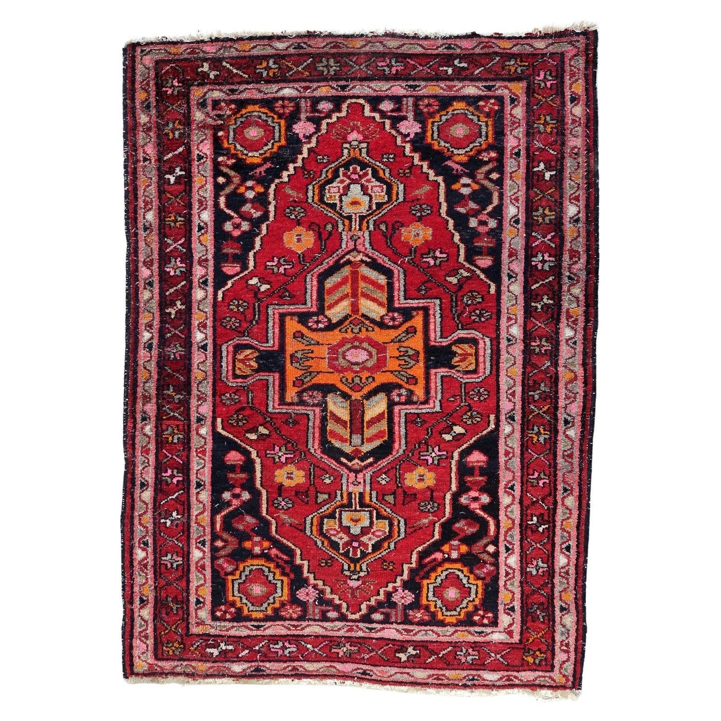 Antique Persian Hamadan rug from the 1920s featuring a dramatic central medallion with vibrant orange chevron patterns.

