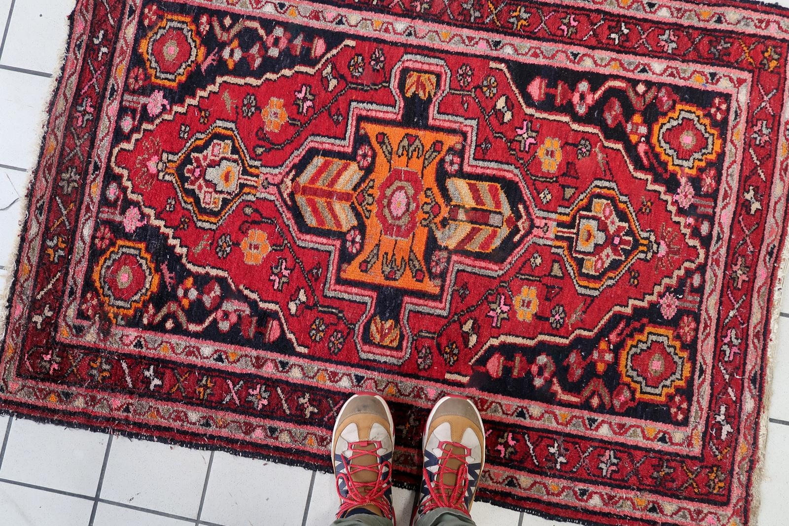 Antique wool rug with a mesmerizing focal point of chevron patterns and geometric medallions.

