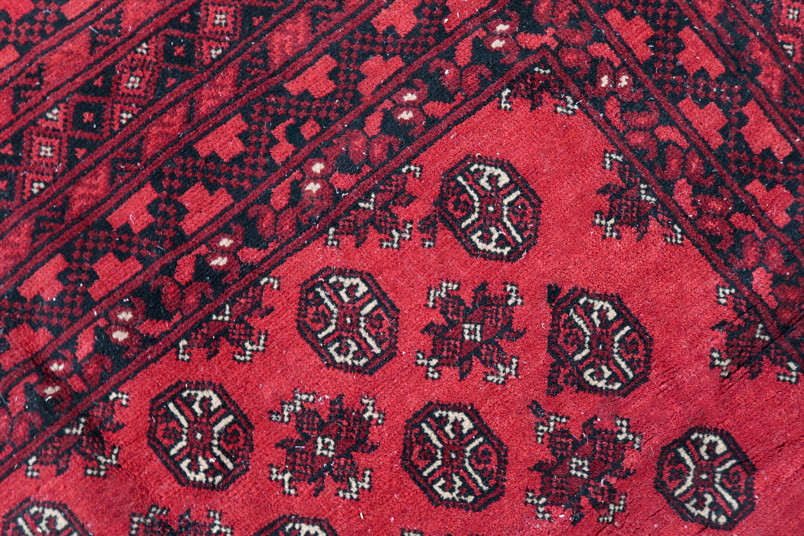 Statement antique rug in a traditional Ersari design, perfect as a foundation for living rooms or dining rooms seeking authentic tribal artistry.

