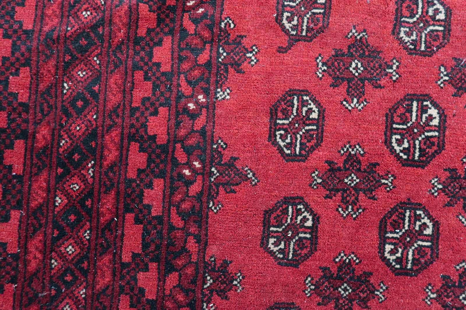 Hand-knotted texture and fine knot density of a 1920s Afghan Ersari tribal carpet, demonstrating exceptional craftsmanship.


