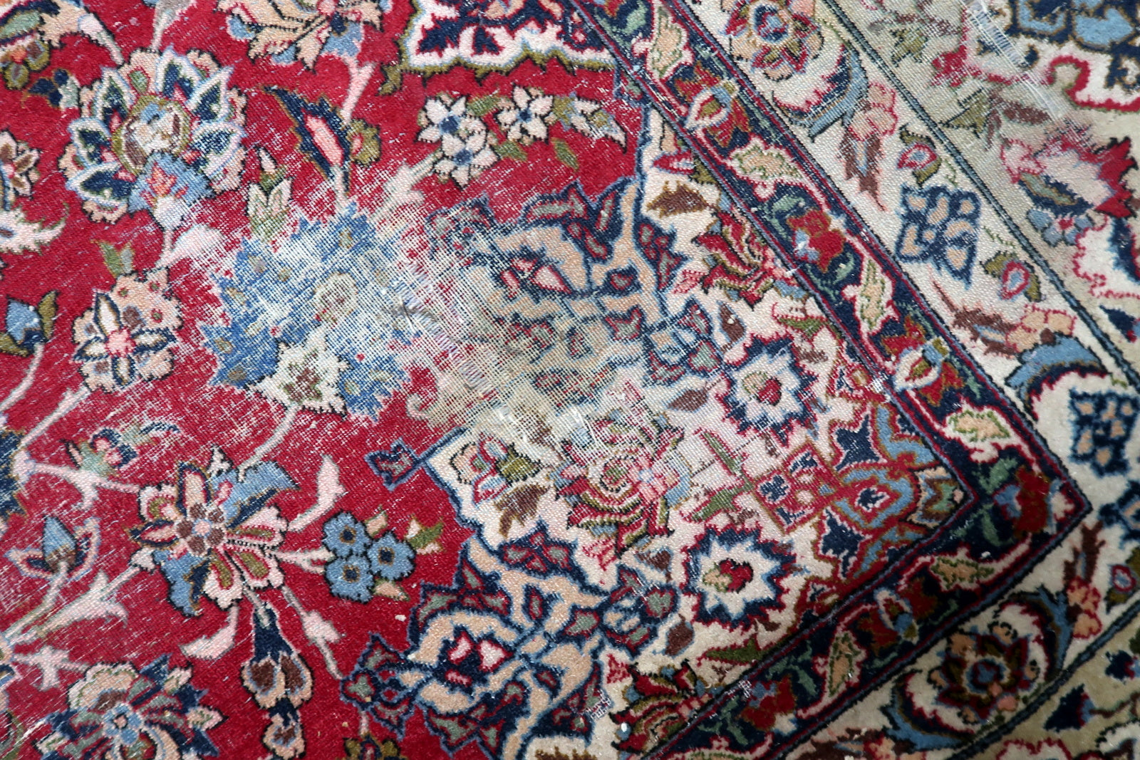 Antique Persian Tabriz rug serving as a grand statement piece for a formal living room or dining room.

