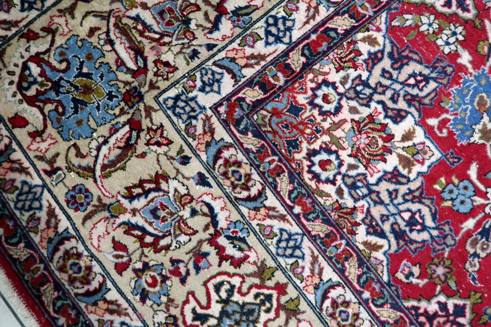 Distressed antique rug with character-rich patina, adding historical authenticity and warmth to a spacious interior.

