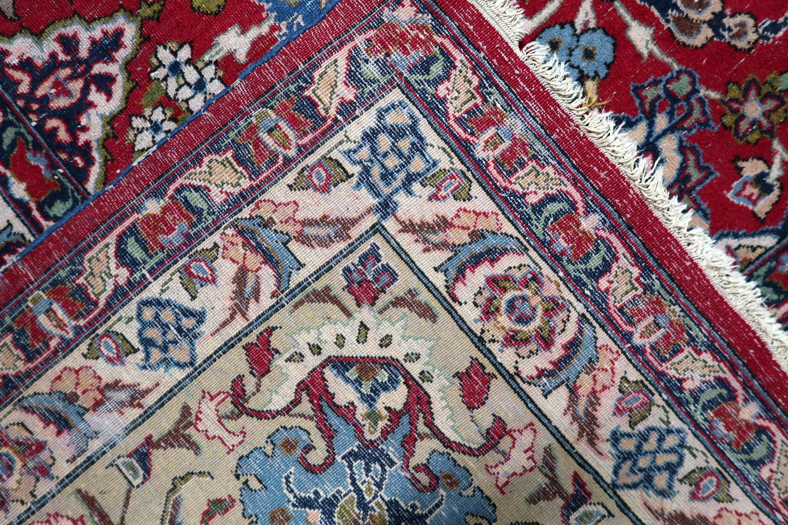 Antique Persian Tabriz rug, hand-knotted wool, early 1900s, crimson red floral field.

