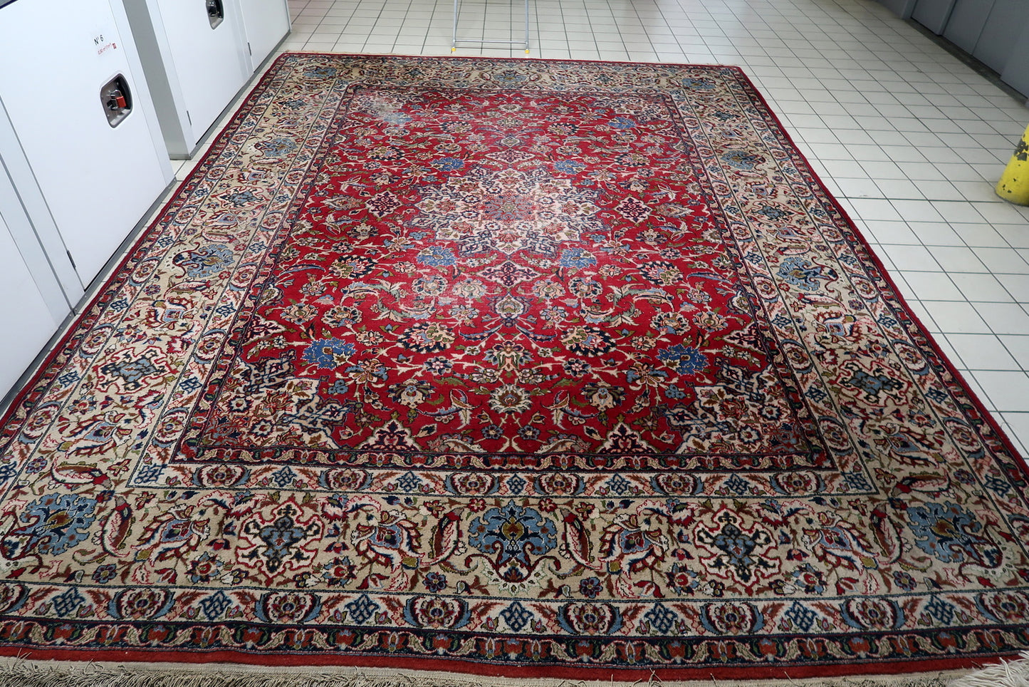 Vintage Persian carpet with distressed patina, central medallion, and multiple borders.

