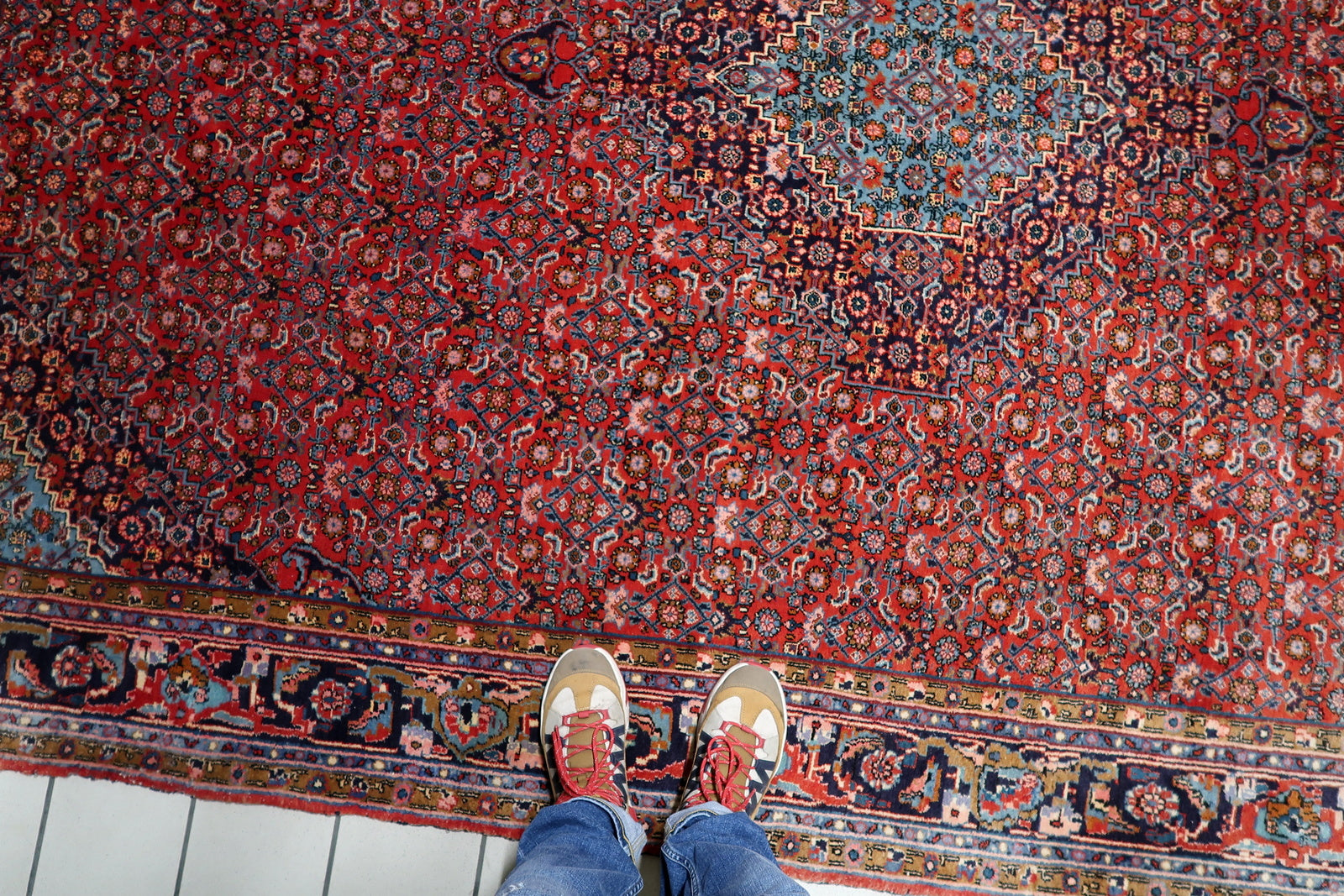 A 1920s Bidjar carpet with authentic age-related fading, adding character and a lived-in feel to a living room or dining space.

