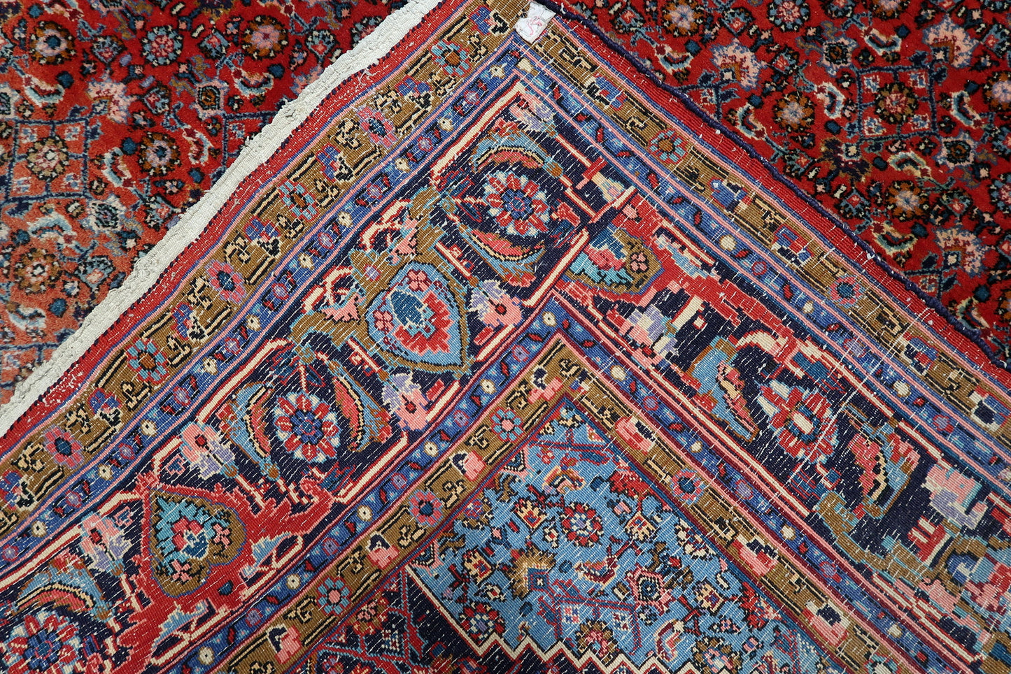 Statement antique rug from Persia, featuring a balanced composition of madder-red field and light blue medallion accents.

