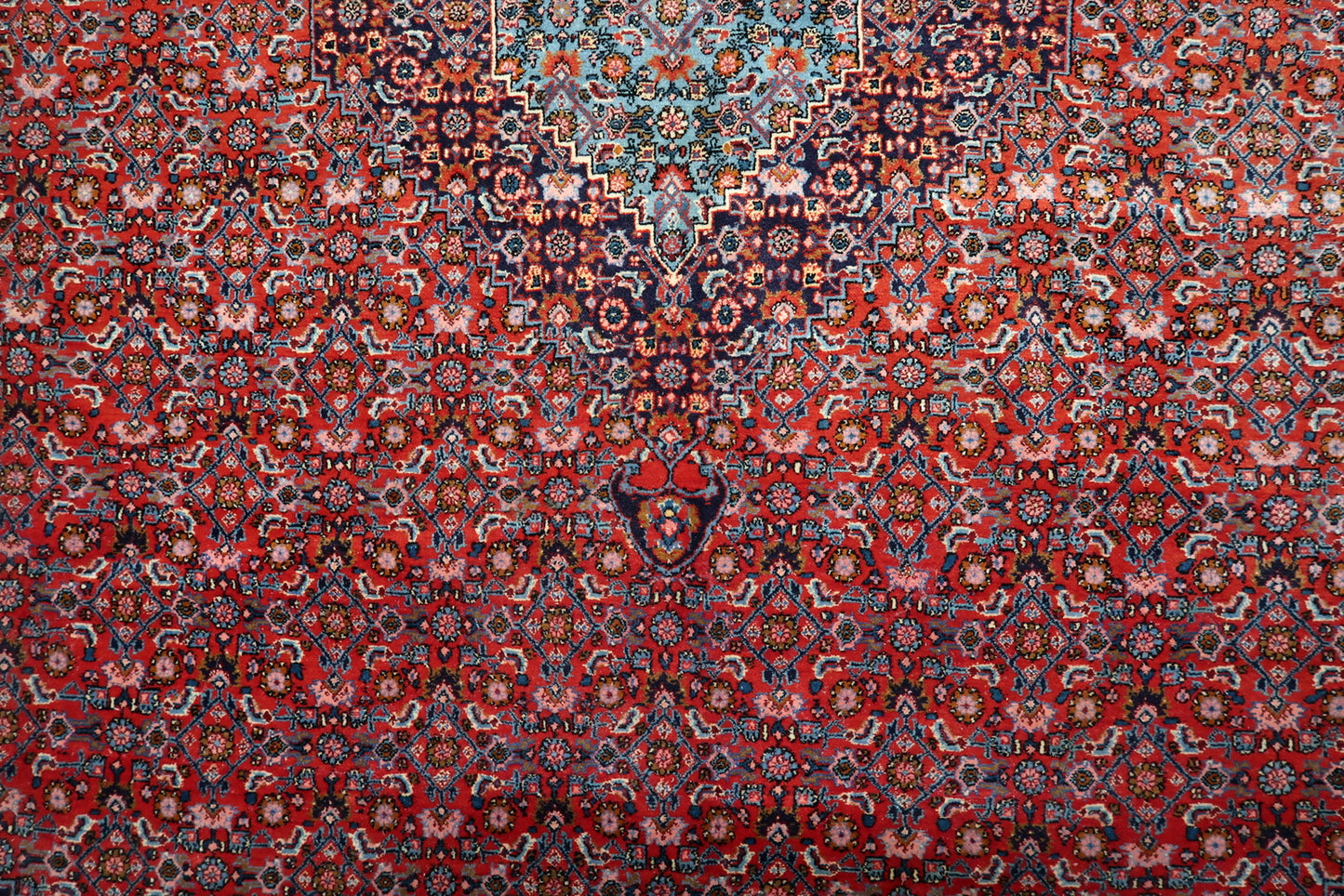 Detail of the all-over Herati (mahi) motif on a 1920s "Iron Rug," providing a sophisticated texture across the main field.

