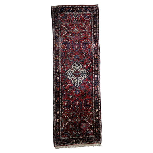 Antique Persian Hamadan runner from the 1920s, hand-knotted wool on cotton, featuring three ivory-ground diamond medallions. 3.5' x 9.9'.

