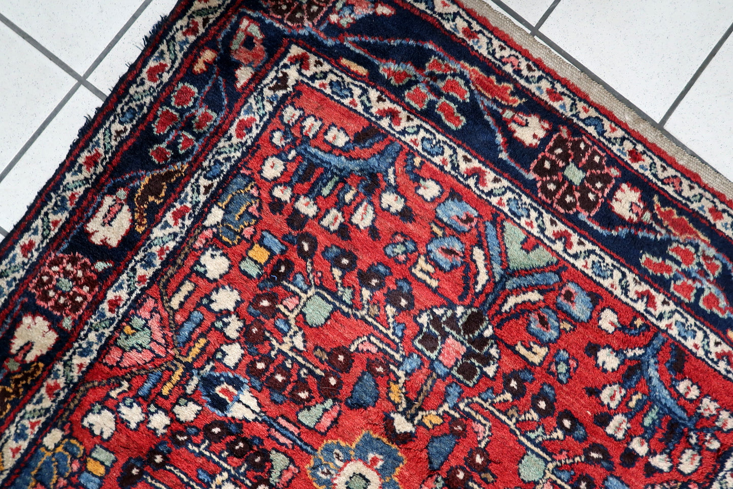 Handmade antique runner measuring 103 x 296 cm, showcasing stylized botanical forms and "tree of life" variations in coral, sage, and ochre.

