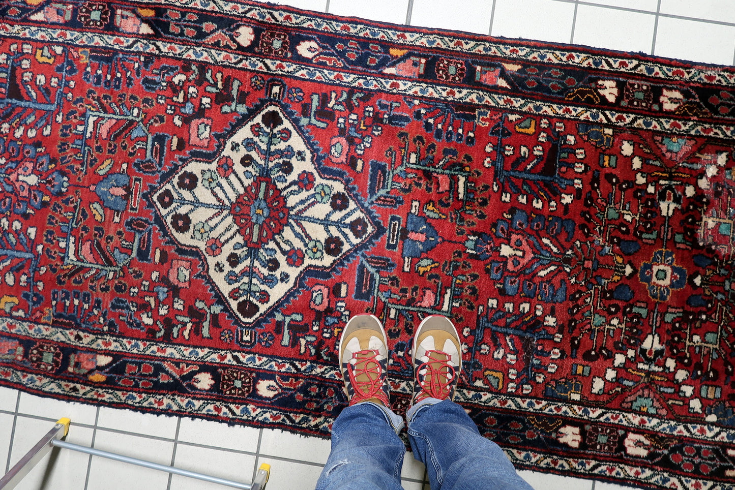 Stylized "tree of life" and botanical variations within the field of a Persian village rug, demonstrating tribal weaving artistry.

