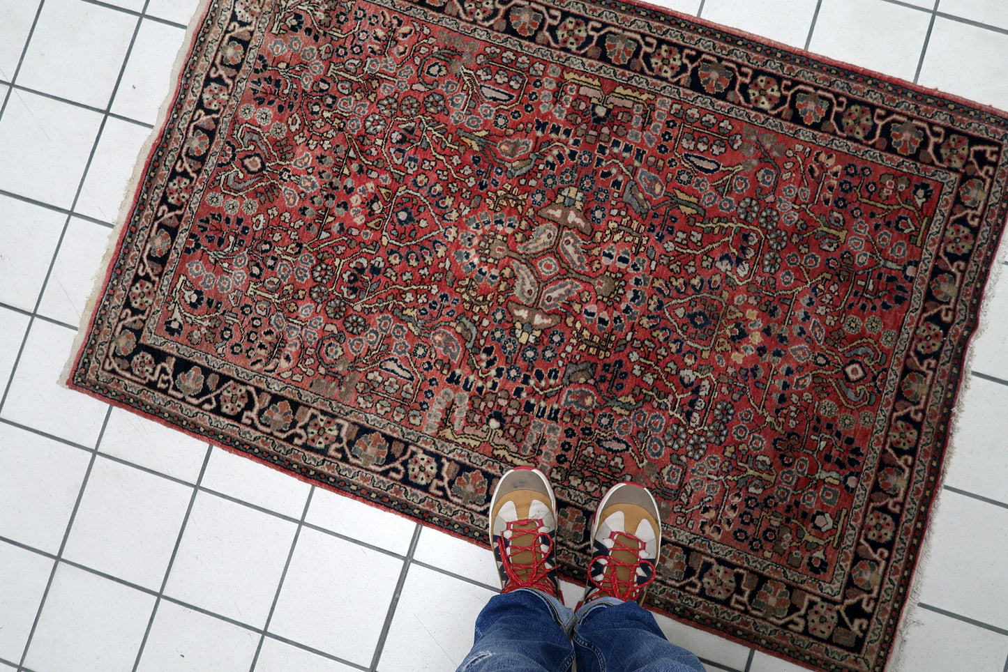 Vintage Persian Hamadan rug serving as a soulful anchor in a contemporary loft, adding instant warmth and history to the space.

