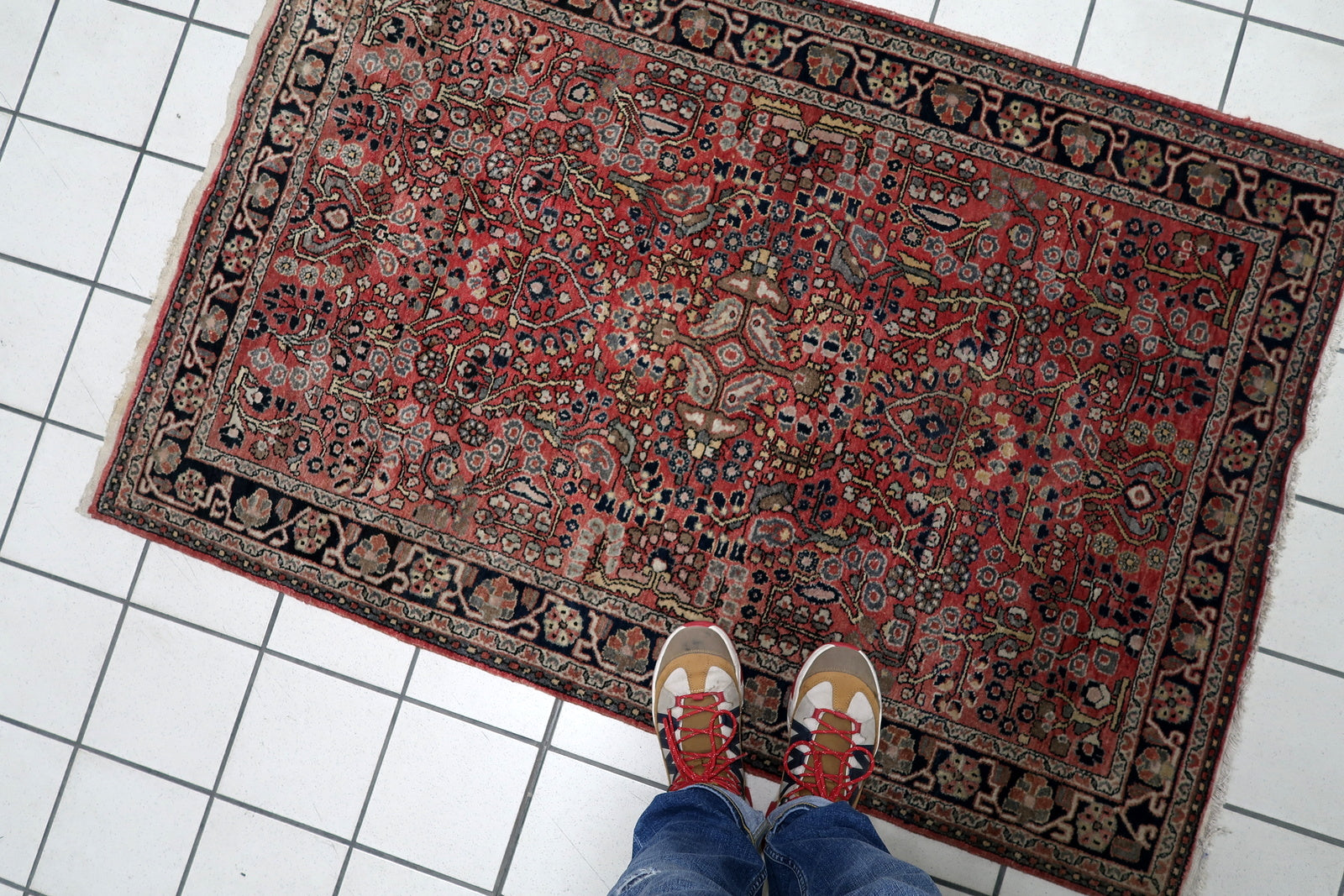 Vintage Persian Hamadan rug serving as a soulful anchor in a contemporary loft, adding instant warmth and history to the space.

