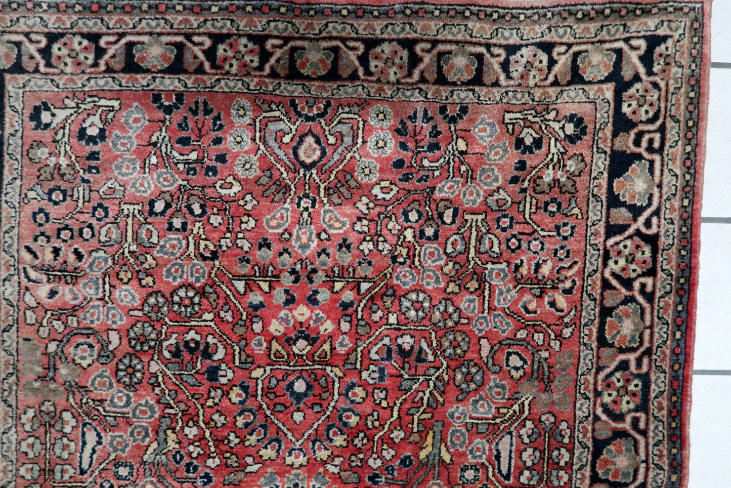 Mid-century Persian Hamadan carpet with dense floral and leaf motifs in midnight blue, ivory, and earth tones. Good vintage condition with low, even pile. 3'3" x 4'11".

