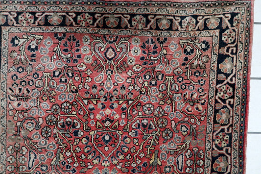 Mid-century Persian Hamadan carpet with dense floral and leaf motifs in midnight blue, ivory, and earth tones. Good vintage condition with low, even pile. 3'3" x 4'11".

