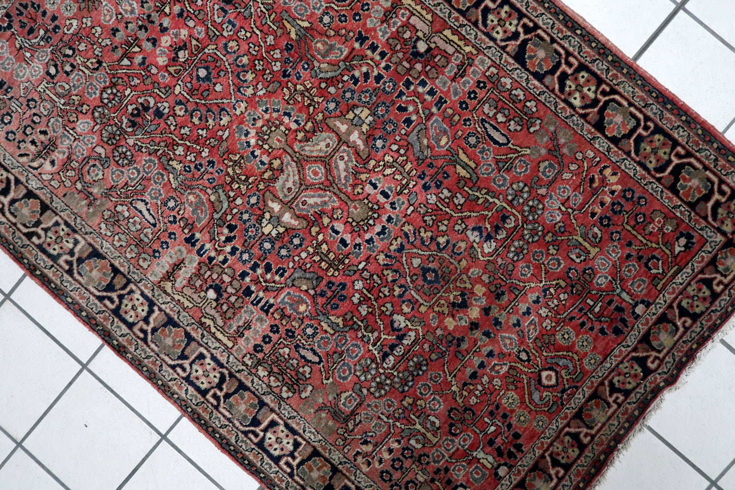 Vintage Persian room-size rug (100 cm x 150 cm) with a sophisticated palette of madder red, midnight blue, and ivory, perfect for adding warmth.

