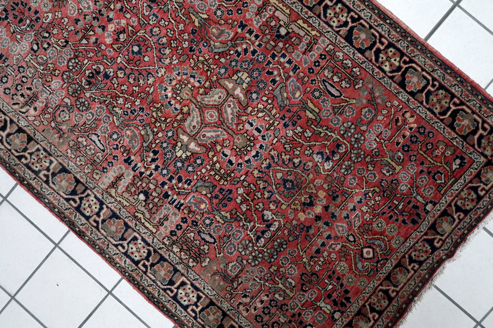 Vintage Persian room-size rug (100 cm x 150 cm) with a sophisticated palette of madder red, midnight blue, and ivory, perfect for adding warmth.

