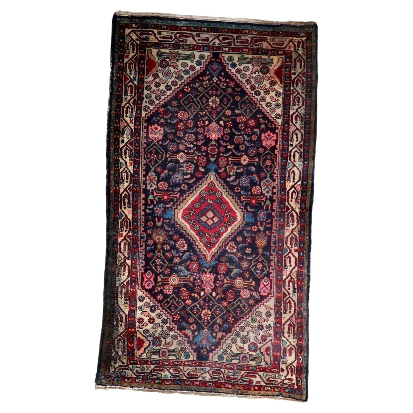 Antique Persian Hamadan rug from the 1920s, hand-knotted wool on cotton, featuring a central diamond medallion on a deep indigo-blue field. 112 x 200 cm.

