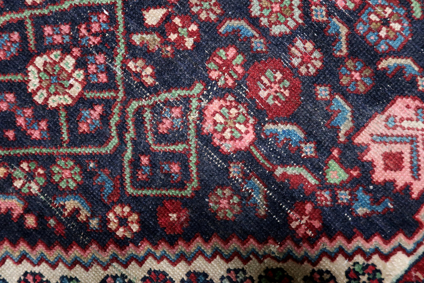 A 1920s village rug with genuine antique patina, perfect for adding lived-in character to a dining room or living area.

