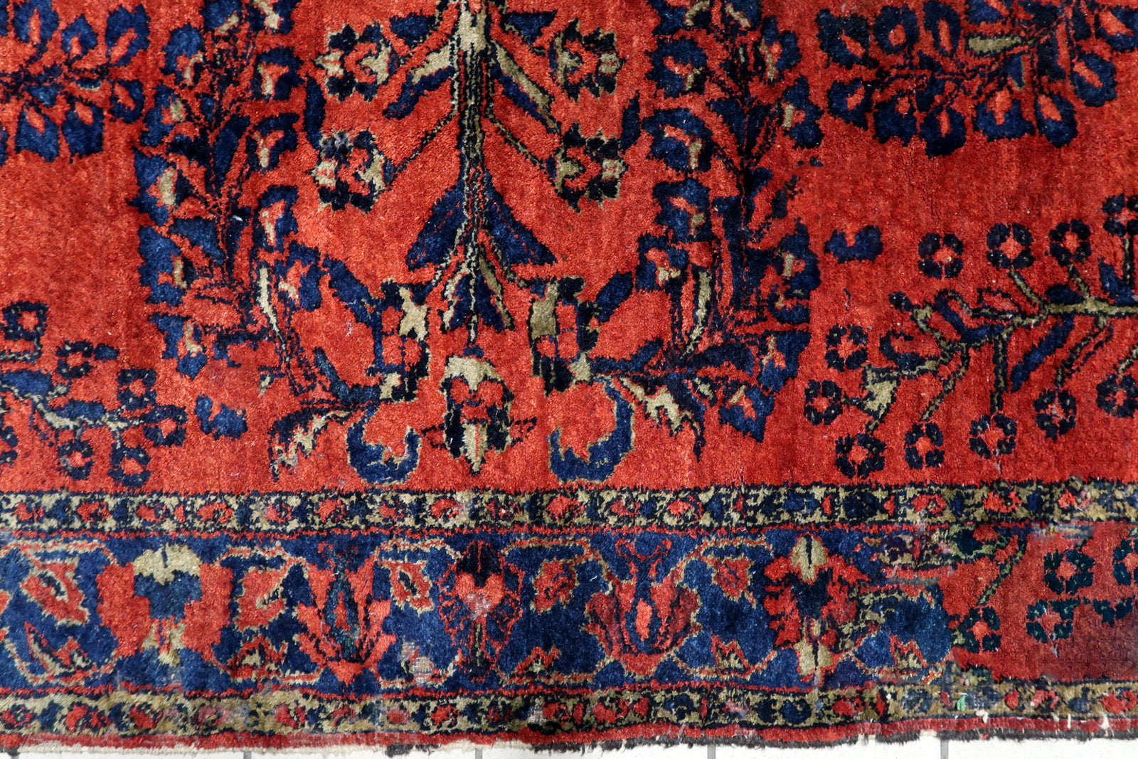 Handmade antique Lilihan rug circa 1920s, showcasing fluid, curvilinear floral sprays and a sophisticated navy border with a repeating vine motif.

