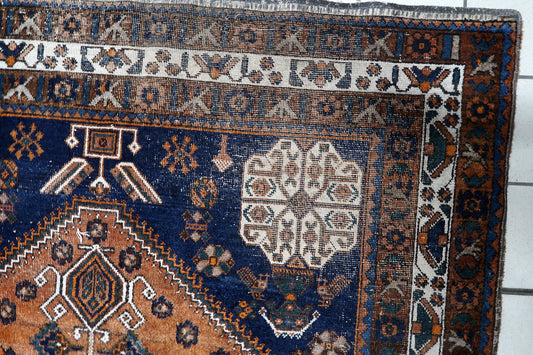 Early 20th century South Persian nomadic rug with ancient tribal symbols, including stylized "S" motifs, stars, and geometric floral heads. 5'1" x 6'9".

