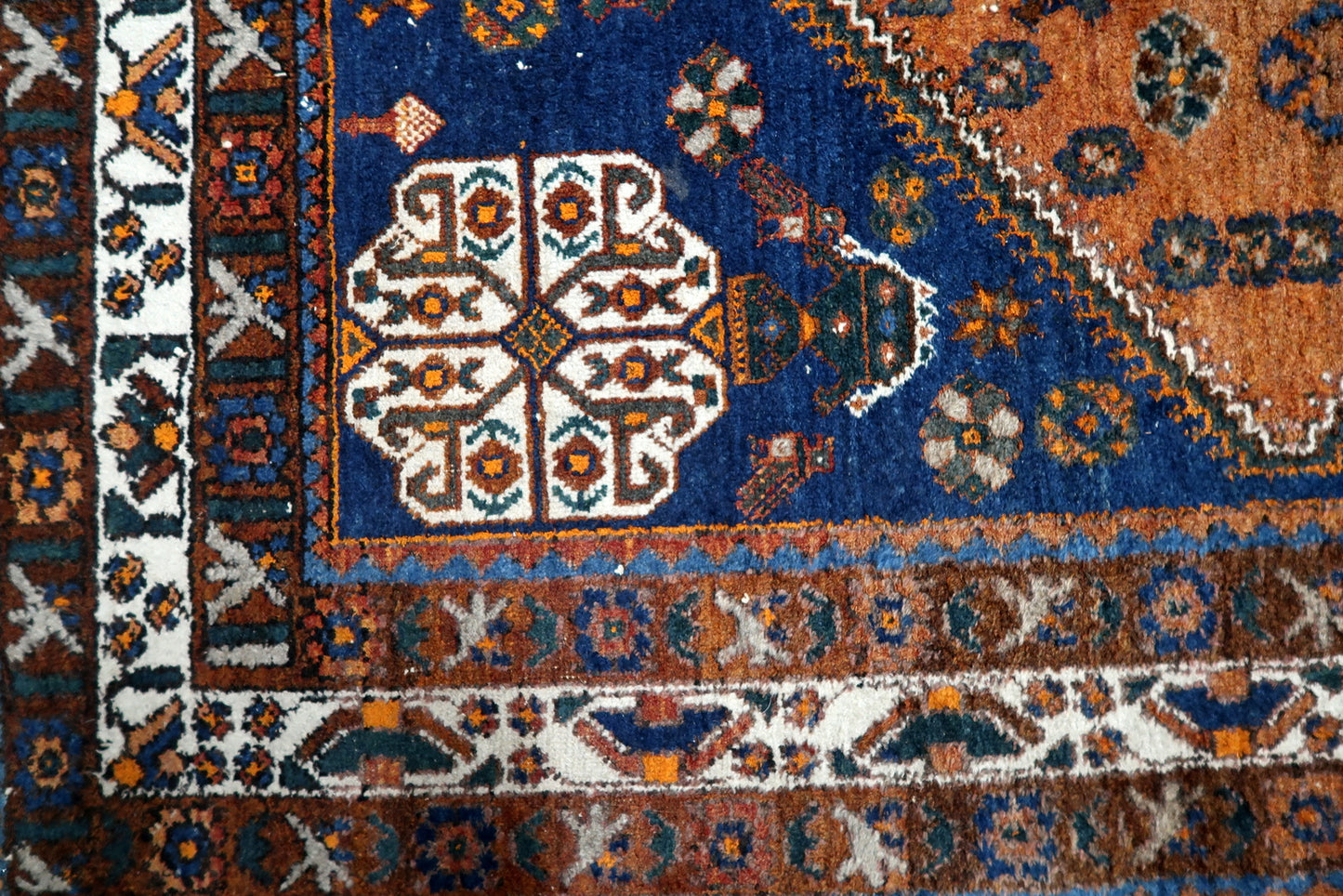 Antique Shiraz Gashkai rug serving as a perfect anchor for a contemporary living room, adding a sense of history and warmth.

