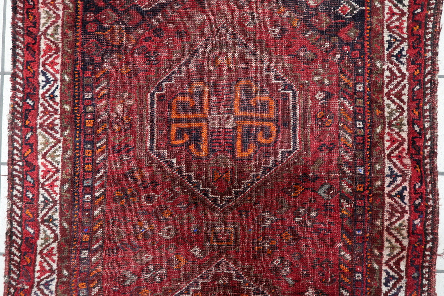 Small antique Persian tribal rug (93 cm x 126 cm) with a beautiful distressed character and authentic century-old patina from the Shiraz region.

