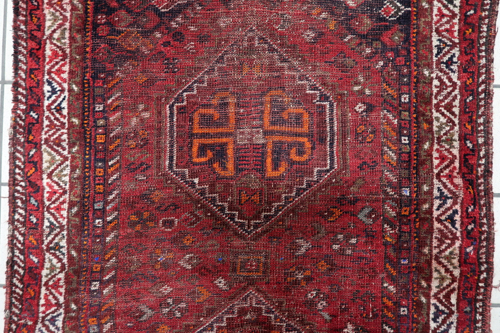 Small antique Persian tribal rug (93 cm x 126 cm) with a beautiful distressed character and authentic century-old patina from the Shiraz region.

