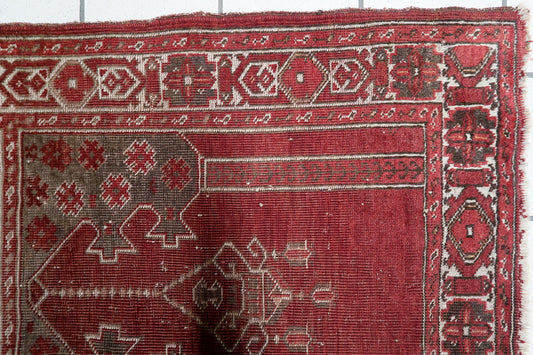 Early 20th century Central Anatolian rug with an architectural gable design and deep charcoal-brown upper spandrels decorated with vibrant red blossoms. 2'7" x 3'6".


