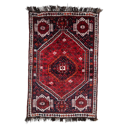 Vibrant antique 1920s Persian Shiraz rug with triple hexagonal medallion design on red field, 4.4 x 6.6 feet.

