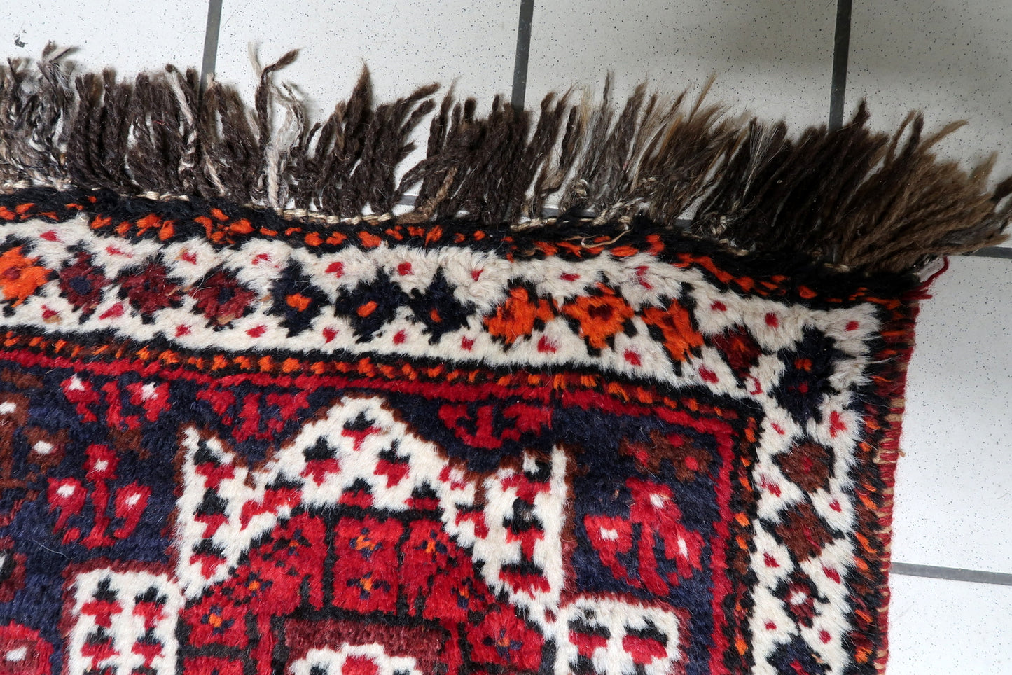 1920s handmade Persian rug with triple medallion layout and sophisticated multi-banded border.

