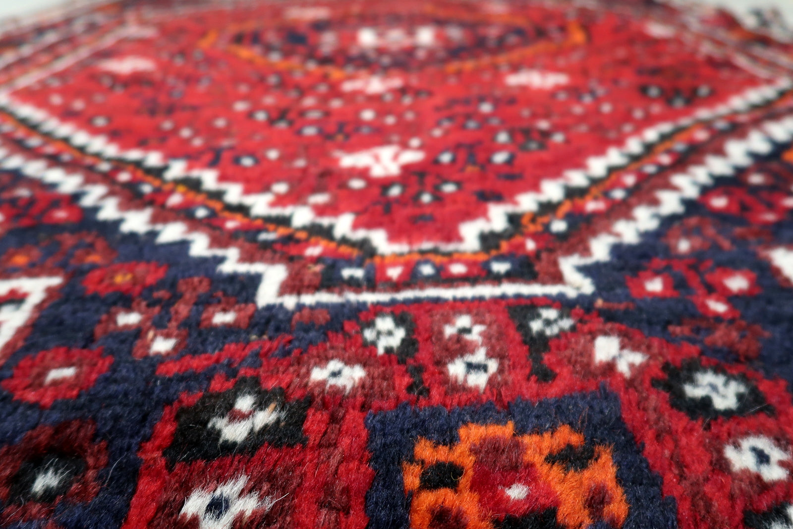 Vintage Persian Shiraz carpet with nested hexagonal medallions and geometric star field design.
