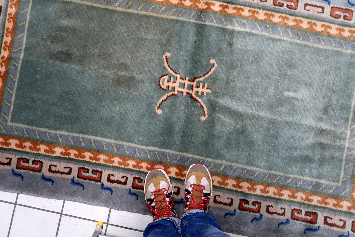 Antique-style Tibetan rug with painterly depth from hand-dyed yarns and cool slate-grey fretwork border