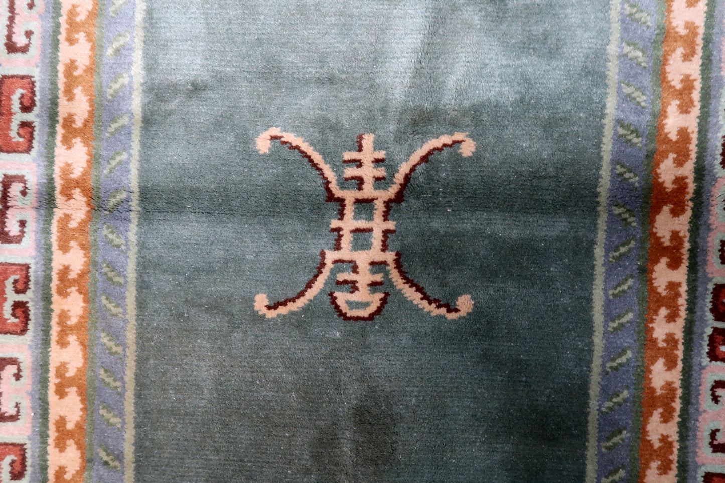 Lush high-quality wool pile texture of a hand-knotted Tibetan rug from Nepal with subtle abrash color variations