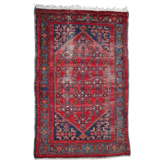 Antique Persian Hamadan distressed rug from the 1920s with geometric diamond medallion on madder-red field, 4.2 x 6.7 feet