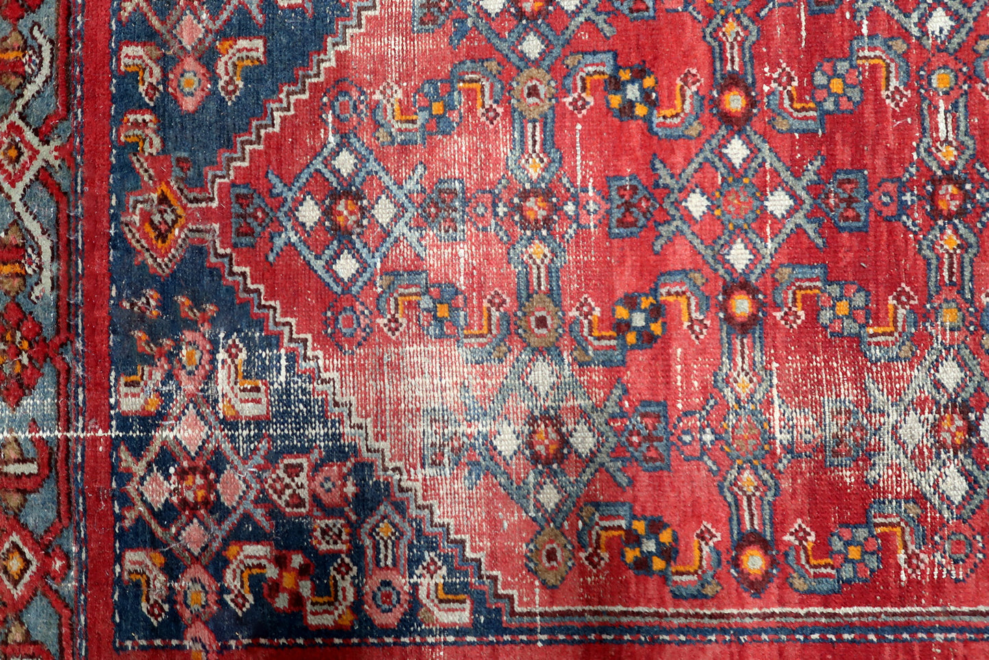 Madder red, navy blue, slate blue and ivory antique Persian rug with geometric diamond medallion and distressed patina