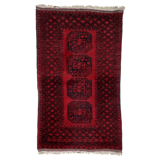 Antique Afghan Ersari rug from the 1920s with four large octagonal elephant foot guls on deep madder-red field, 3.9 x 6.4 feet