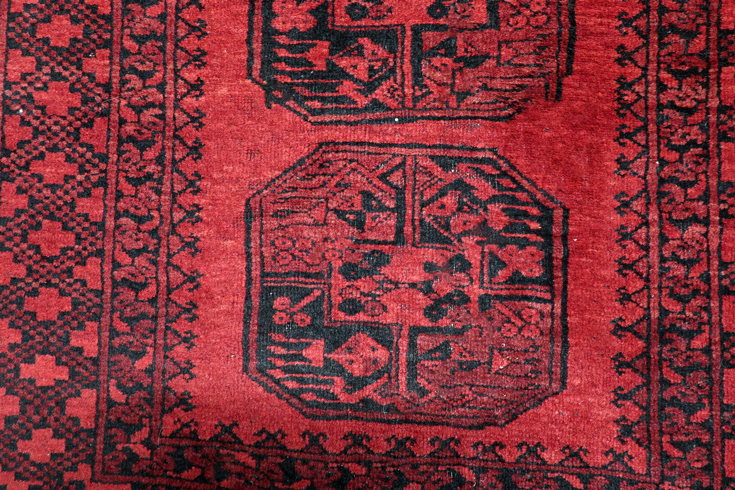 Detailed border of a 1920s Ersari rug showing densely packed star and diamond fretwork patterns
