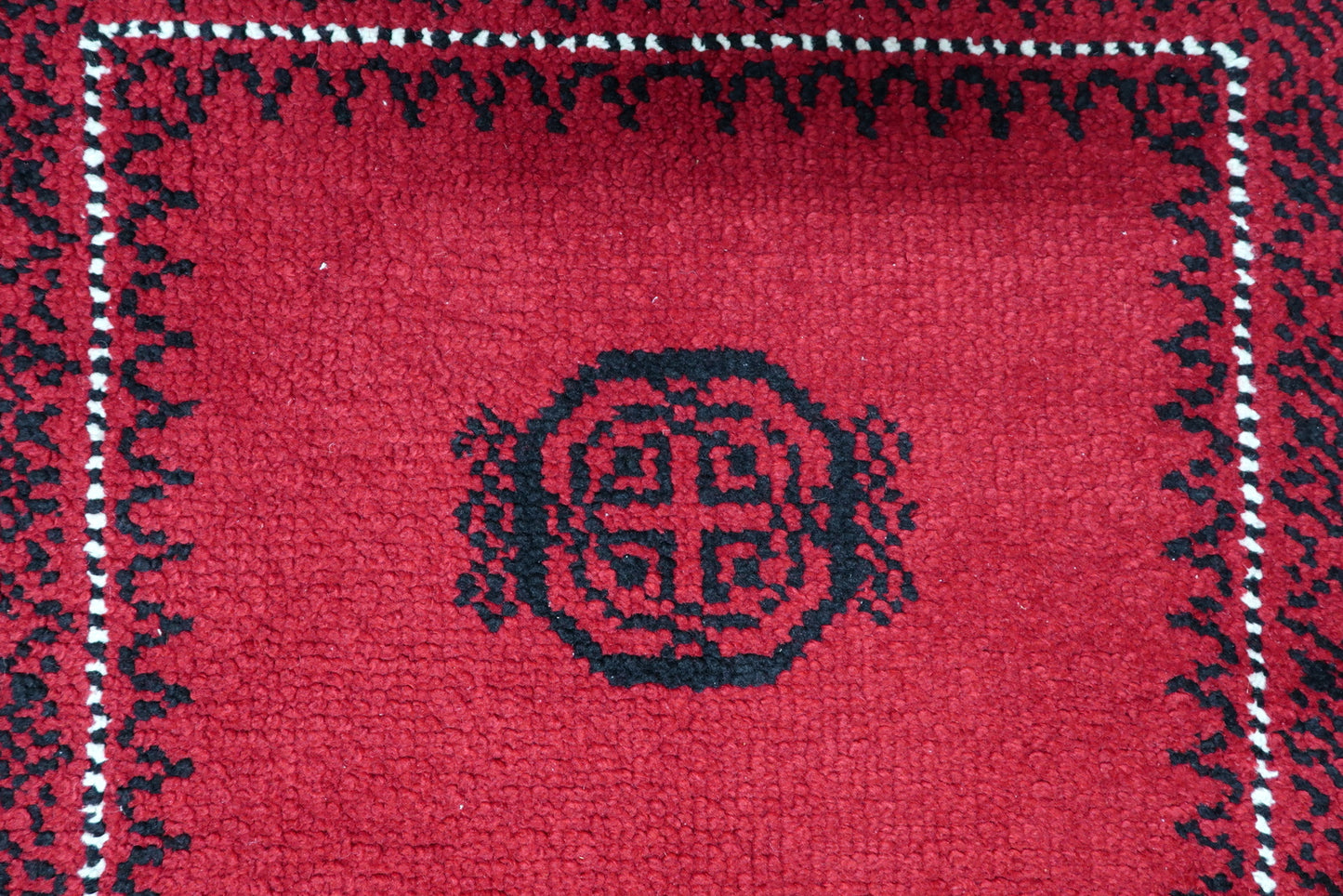 Detailed wide outer border showing striking Greek key and sawtooth motif in contrasting ivory and black
