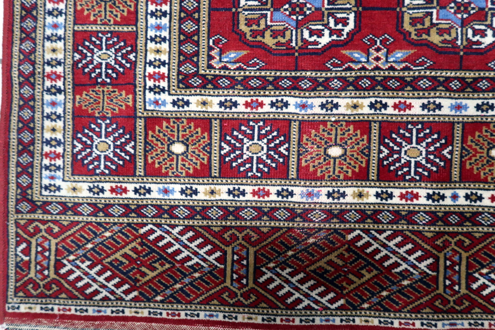 Vintage 1960s Central Asian Bukhara carpet with signature gul motifs and multiple decorative border bands